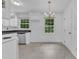Bright kitchen features white cabinets, stainless steel dishwasher, and natural light at 804 Colonial Dr, Raleigh, NC 27603