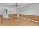 Bright room with wood paneling, two exterior doors, and overhead fan at 804 Colonial Dr, Raleigh, NC 27603