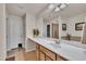 This bathroom offers a vanity with double sinks, a large mirror, and features tile floors for added convenience at 8111 Yaxley Hall Dr, Raleigh, NC 27616