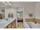 This bathroom features a vanity with double sinks, tile floors, and an adjacent bathtub with tile walls at 8111 Yaxley Hall Dr, Raleigh, NC 27616