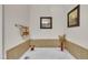 This well-kept bathtub is surrounded by decorative elements, including tile walls, paintings, and wine glasses at 8111 Yaxley Hall Dr, Raleigh, NC 27616