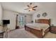 Spacious bedroom with ceiling fan, large window, and wood furniture at 8111 Yaxley Hall Dr, Raleigh, NC 27616