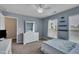 This bedroom features a ceiling fan, blue walls, white furniture, and natural lighting at 8111 Yaxley Hall Dr, Raleigh, NC 27616