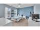 Bright bedroom features a ceiling fan, blue accent wall with decal, and floating shelves at 8111 Yaxley Hall Dr, Raleigh, NC 27616