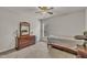 This bedroom features carpeted floors, a neutral color palette, and contains a large window for ample natural light at 8111 Yaxley Hall Dr, Raleigh, NC 27616