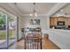 Bright dining area features a wood table, decorative lighting, and sliding glass doors to the outdoor space at 8111 Yaxley Hall Dr, Raleigh, NC 27616