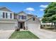 Attractive townhome with two-car garage, manicured lawn, neutral siding, and welcoming front door with brick accents at 8111 Yaxley Hall Dr, Raleigh, NC 27616