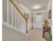 Spacious foyer featuring a staircase, neutral paint, tile flooring, and an inviting view of the front entrance at 8111 Yaxley Hall Dr, Raleigh, NC 27616
