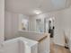 Open upstairs hallway bathed in natural light and neutral walls at 8111 Yaxley Hall Dr, Raleigh, NC 27616