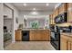 Bright kitchen with a view to the living room showcasing wooden cabinets and black appliances at 8111 Yaxley Hall Dr, Raleigh, NC 27616