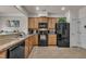Well-lit kitchen features stainless steel appliances, wooden cabinets, and tile flooring at 8111 Yaxley Hall Dr, Raleigh, NC 27616