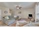 Well-lit living room featuring a sectional sofa, neutral walls, ceiling fan, and an inviting, cozy atmosphere at 8111 Yaxley Hall Dr, Raleigh, NC 27616