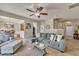 Inviting living room featuring a sectional sofa, ceiling fan, and seamless flow into the dining and kitchen areas at 8111 Yaxley Hall Dr, Raleigh, NC 27616