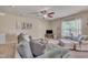 Cozy living room with comfortable seating, neutral decor, ceiling fan, and ample natural light, creating a welcoming space at 8111 Yaxley Hall Dr, Raleigh, NC 27616