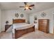 This main bedroom has a ceiling fan, a neutral color palette, and an ensuite bathroom for added convenience at 8111 Yaxley Hall Dr, Raleigh, NC 27616