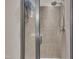 This tiled shower stall features a modern shower head, clear-glass doors, and chrome fixtures for a sleek look at 8111 Yaxley Hall Dr, Raleigh, NC 27616