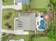 Aerial view of a landscaped property featuring a large in-ground pool, patio area, and firepit at 814 Covered Bridge Trl, Chapel Hill, NC 27517