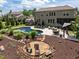 Aerial view of landscaped backyard with pool, firepit, gazebo, shed, and manicured lawn, perfect for outdoor living at 814 Covered Bridge Trl, Chapel Hill, NC 27517