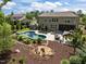 Large backyard featuring a swimming pool, patio with lounge furniture, fire pit, and manicured landscaping at 814 Covered Bridge Trl, Chapel Hill, NC 27517