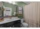 Well-lit bathroom with a decorative mirror, neutral shower curtain, and earth-tone decor at 814 Covered Bridge Trl, Chapel Hill, NC 27517