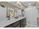 Bright bathroom with double sinks, neutral shower curtain, and dark wood cabinets at 814 Covered Bridge Trl, Chapel Hill, NC 27517