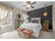 Beautiful bedroom featuring a decorative accent wall, fan, and pendant lighting at 814 Covered Bridge Trl, Chapel Hill, NC 27517