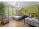 Bedroom features two twin beds, hardwood floors, and a modern light fixture at 814 Covered Bridge Trl, Chapel Hill, NC 27517