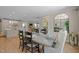 An open-concept dining room with modern table and black chairs, wood floors and neutral color palette at 814 Covered Bridge Trl, Chapel Hill, NC 27517