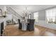 Elegant dining room with fireplace, stylish lighting, staircase and designer wallpaper at 814 Covered Bridge Trl, Chapel Hill, NC 27517