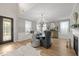 Elegant dining room with stylish lighting, large windows, wainscoting and designer wallpaper at 814 Covered Bridge Trl, Chapel Hill, NC 27517