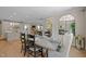 Open-concept dining room featuring a glass-top dining table, seating for six, and hardwood floors at 814 Covered Bridge Trl, Chapel Hill, NC 27517