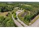 Scenic view of a grand community entrance with lush landscaping, a serene pond with a fountain, and a charming gazebo at 814 Covered Bridge Trl, Chapel Hill, NC 27517