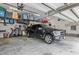 Well-organized garage featuring overhead storage racks and a black pickup truck parked inside at 814 Covered Bridge Trl, Chapel Hill, NC 27517