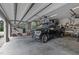 Spacious garage featuring overhead storage racks and a black pickup truck, offering ample space for vehicles and storage at 814 Covered Bridge Trl, Chapel Hill, NC 27517