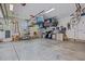 Spacious garage with ample storage, featuring shelving units, overhead racks, and epoxy flooring at 814 Covered Bridge Trl, Chapel Hill, NC 27517