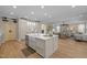 Open-concept kitchen featuring a large island with seating, modern appliances, and open views at 814 Covered Bridge Trl, Chapel Hill, NC 27517
