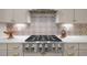The kitchen features a stainless steel stove with a decorative tile backsplash and custom cabinetry at 814 Covered Bridge Trl, Chapel Hill, NC 27517