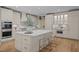 Bright kitchen featuring a spacious island with quartz countertop, stainless steel appliances, and light wooden floors at 814 Covered Bridge Trl, Chapel Hill, NC 27517