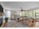 Spacious living room with large windows, neutral tones, comfortable seating and modern decor at 814 Covered Bridge Trl, Chapel Hill, NC 27517