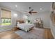 Spacious main bedroom with wood floors, a rattan bed, stylish chandelier, and a cozy rug at 814 Covered Bridge Trl, Chapel Hill, NC 27517