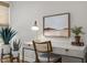 Bright office space features a desk with plants, art and a comfortable chair with cane backing at 814 Covered Bridge Trl, Chapel Hill, NC 27517