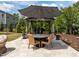 Outdoor dining area with a table, umbrella, and scenic views of the gazebo and backyard at 814 Covered Bridge Trl, Chapel Hill, NC 27517