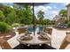 Elegant pool area with a table, a dining set, sun loungers, and lush landscaping for ultimate relaxation at 814 Covered Bridge Trl, Chapel Hill, NC 27517