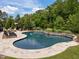 Beautiful freeform pool with stone accents and lush landscaping to create your own private backyard oasis at 814 Covered Bridge Trl, Chapel Hill, NC 27517