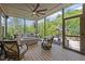 Inviting screened-in porch with comfortable seating, a ceiling fan, and views of the backyard at 814 Covered Bridge Trl, Chapel Hill, NC 27517