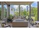 Relaxing screened-in porch with cozy seating, a wooden deck, and a tranquil backyard view at 814 Covered Bridge Trl, Chapel Hill, NC 27517