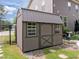 Backyard shed offers extra storage with stylish design; complements the home's aesthetic and landscaping at 814 Covered Bridge Trl, Chapel Hill, NC 27517