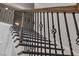 Close up on staircase with decorative wrought iron railing and hardwood trim at 814 Covered Bridge Trl, Chapel Hill, NC 27517