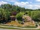 Multi-tiered water feature with lush greenery and serene waterfalls cascading into a pond at 814 Covered Bridge Trl, Chapel Hill, NC 27517