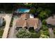 Aerial view of home showcasing expansive backyard, swimming pool, and meticulously maintained landscaping at 821 Woodburn Rd, Raleigh, NC 27605